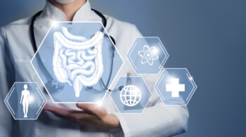 Unrecognizable female doctor holding graphic virtual visualization model of Intestine organ in hands. Multiple medical icons on the background. colite